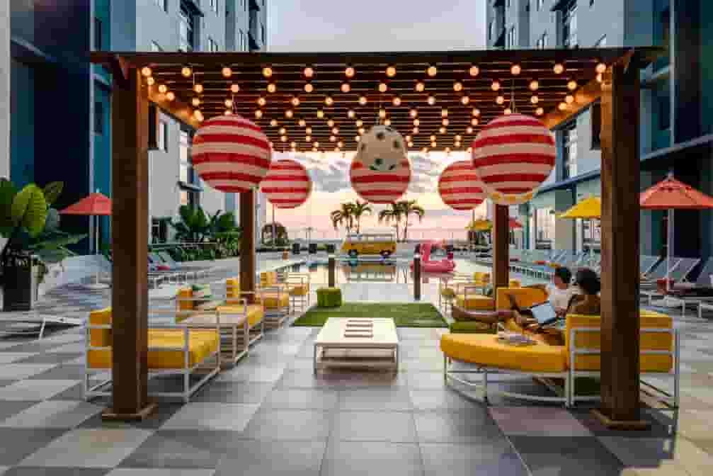 Identity Miami Sun Deck at sun set with pool and the Identity Bus
