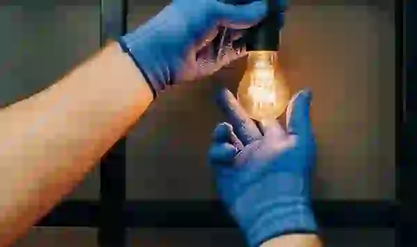 Maintenance professional changing a lightbub