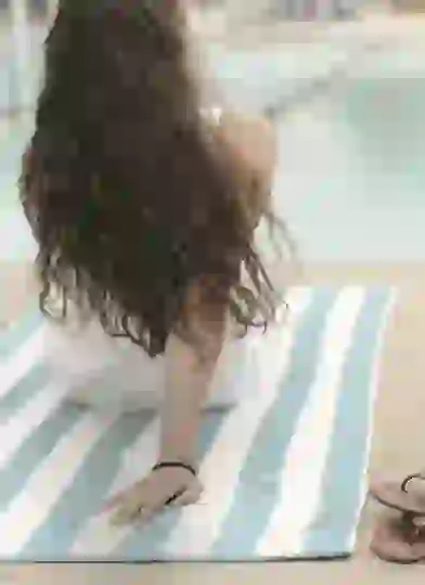 Resident lounging by pool at Identity Miami